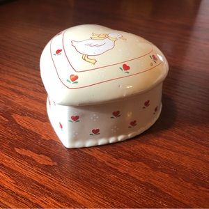 White heart shaped ceramic trinket box with a duck.